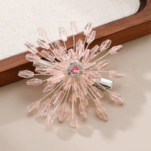 Detail of pink crystal flower hair clip featuring beaded petals and silver metal duckbill base