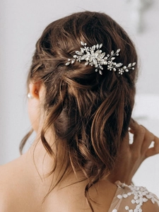 Detail of silver bridal hair vine with marquise crystals and pearls in a braided hairstyle