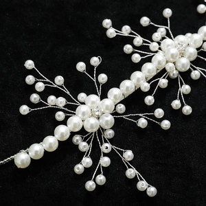 Handmade pearl and crystal bridal headband with silver wire branches on black background