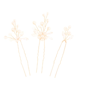 Detailed macro view of three bridal U-shaped hair pins with gold wire and pearls