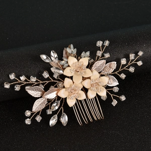 Elegant bridal hair comb with cream flowers and crystal beads on a golden base