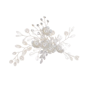 Macro detail of handmade bridal hair comb with pearls, crystals and silver wire