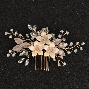 Elegant bridal hair comb with cream flowers and crystal branches on a metal base