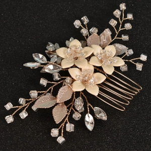 Handmade bridal hair comb with cream matte flowers and rose gold crystals on black background