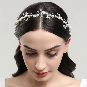 Detail of bride wedding hair vine with white pearls and sparkling crystal stones