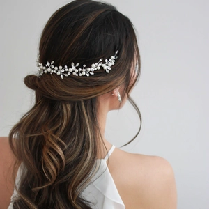 Elegant bridal hair vine with white pearls and marquise rhinestones on a brunette model