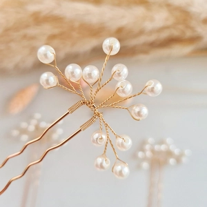 Elegant gold bridal hair pin with handcrafted pearls in a U-shape for wedding hairstyles