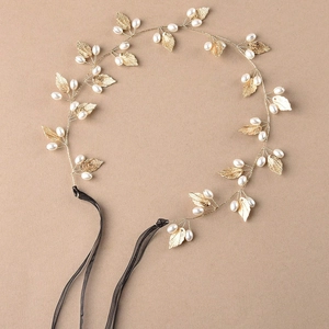 Golden bridal hair vine with white pearls and metallic leaves on black ribbons