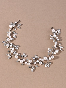 Close-up of bridal hair vine with marquise crystals, white pearls and black wire