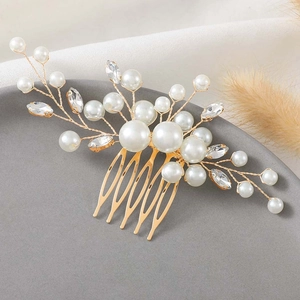 Elegant bridal hair comb with pearls and rhinestones on gold wire base in a scenic view