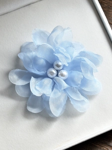 Détail de fleur en organza bleu clair avec perles élégantes pour mariage et plage
