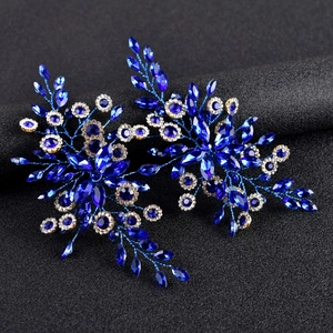 Close-up of blue crystal hairpiece with marquise-cut stones and white rhinestones
