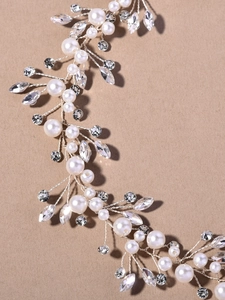 Close-up of bridal headband with white pearls and marquise crystals on silver wire