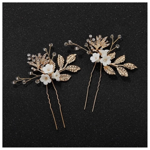 Elegant gold U-shaped bridal hair pins with white ceramic flowers and sparkling crystals