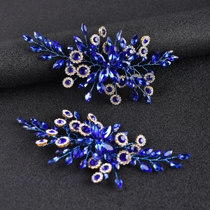 Detail view of navy blue marquise crystal hair accessories with floral vine design