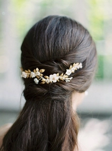 Elegant gold leaf and white flower bridal headpiece with pearl beads on dark hair