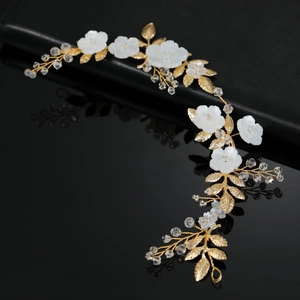 Elegant gold bridal headband with white shell flowers, golden leaves and crystals