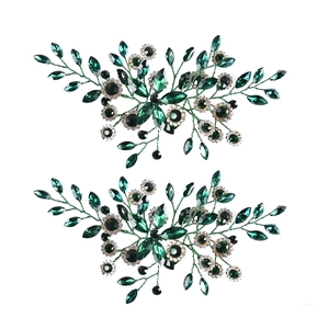 Detail of dark green marquise crystal hairpins with sparkling rhinestone accents