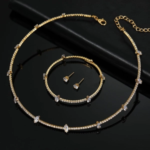Elegant bridal jewelry set including crystal necklace, bracelet and earrings in gold plating