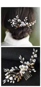Detailed view of handmade pearl floral hair comb with white crystal petals and gold leaves