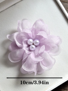 Détail macro d'une pince à cheveux fleur en mousseline lavande de 10cm avec perles