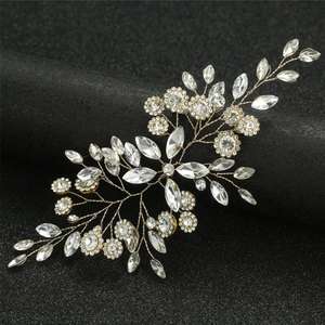 Detail of handcrafted silver bridal hairpiece with marquise crystals on a black stand
