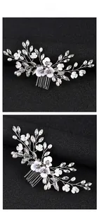 Close-up of handmade white flower hair comb with pearls and crystals for bridal styling