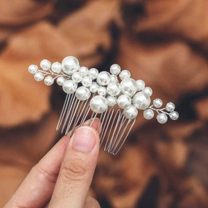 Elegant bridal hair comb with handmade white pearl clusters and silver metal prongs for weddings