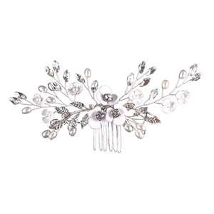 Detail of bridal hair comb with white pearls, crystals, and flowers on silver wire