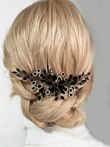 Detailed view of leaf design hair comb with black marquise stones on blonde hair