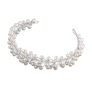 Macro shot of handcrafted pearl bridal headband with intricate silver wire weaving detail