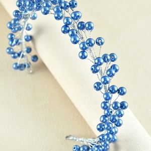 Close-up of handmade bridal headband with blue pearls and silver wire berries