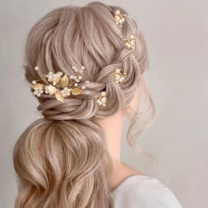 Elegant bridal hair pins set with golden leaves and white pearls for wedding hairstyles