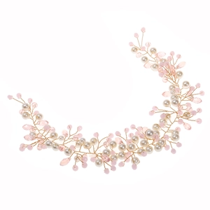 Detail of bridal headband with white pearls and pink crystals on gold wire