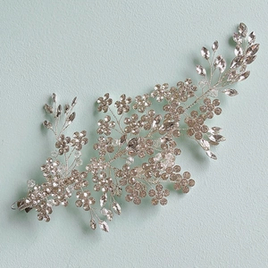 Exquisite bridal hair clip set with floral rhinestones and crystals on mint background