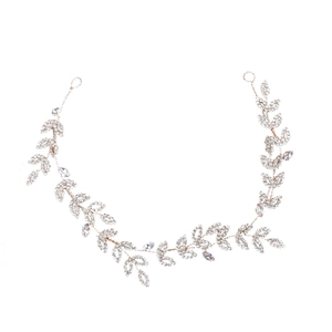 Detail of vine-style bridal headpiece with gold wire leaves and marquis rhinestones