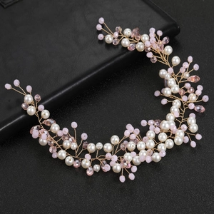 Detail of bridal hair vine with pink crystal beads and white pearls on soft gold wire