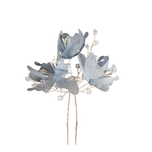 Detail of light blue fabric flowers with white faux pearls on a bridal hair pin