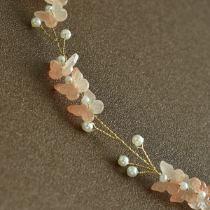 Close-up of handmade bridal headpiece with pearl accents and frosted butterfly petals