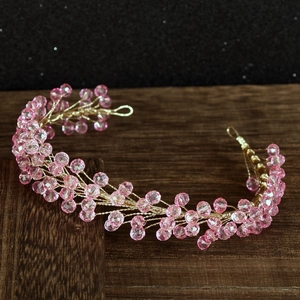 Detail showing pink crystal beads hand-woven on gold wire for bridal hair accessory