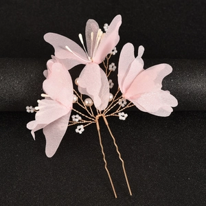 Detail of pink silk yarn flowers hair pin with pearls and golden wire for weddings