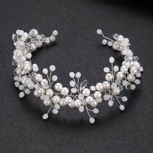 Elegant bridal headpiece with white pearls and clear crystals on a silver vine band