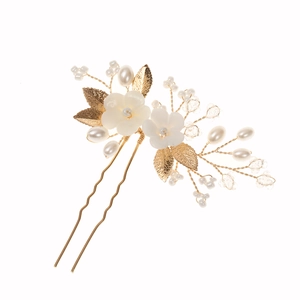 Handmade bridal hair pin with white ceramic flowers and golden leaf accents on white background