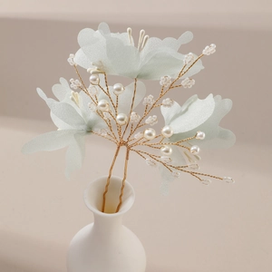 Handmade bridal hair pin with green fabric flowers, pearls, and gold wire for weddings