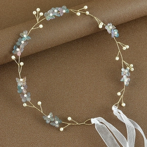 Detail showing bridal headband with gold wires, pearls and colorful butterfly accents