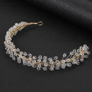Elegant gold bridal hairband with crystal beads and wire weaving for wedding hair styling
