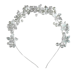 Detailed macro view of white floral petals and diverse pearls on a silver metal headband