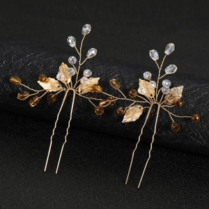 Handmade golden bridal hair pins with hollow metal leaves and amber crystal beads for weddings