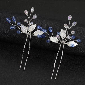 Detail of silver leaf hair pins with deep blue crystals and shimmering beads set of two