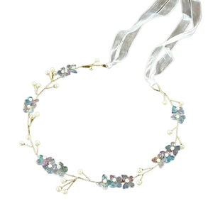 Detail of bridal headband with blue butterflies and white pearls on gold twisted wire